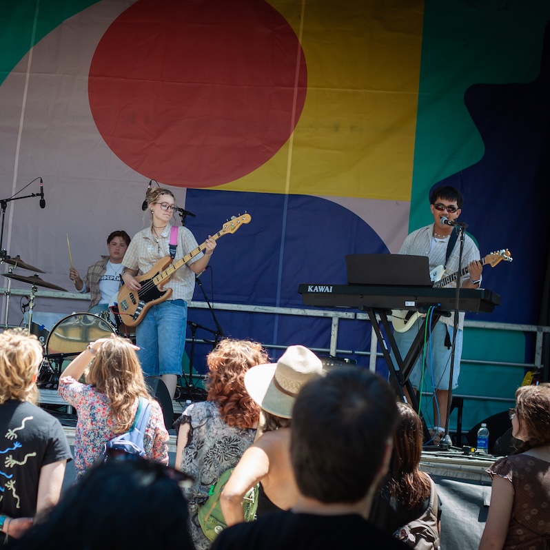 a band plays in front of a crowd.